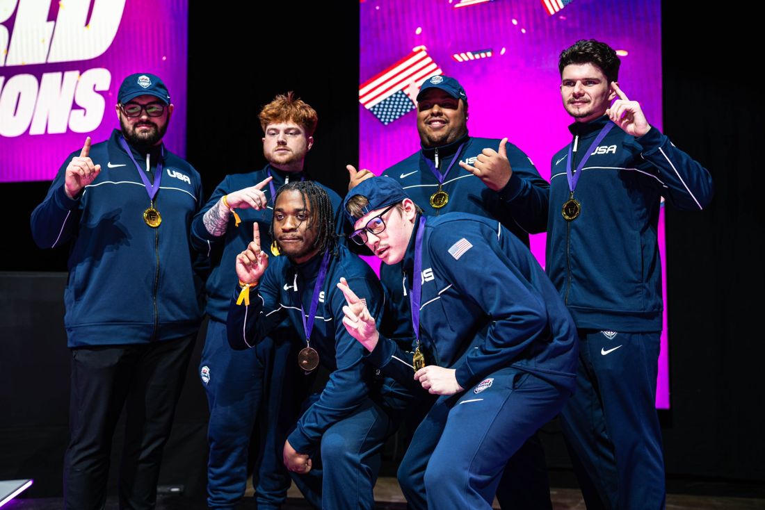 The USA Basketball E-National team on stage with gold medals, Coach Lance on the left